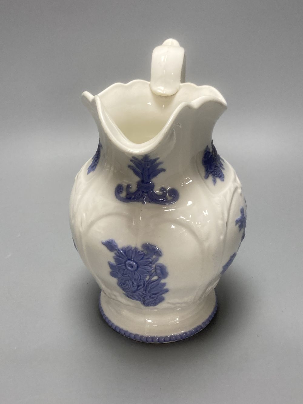 Four early 19th century Staffordshire jugs, each with lilac coloured floral applied panels, one dated 1826, tallest 22cm